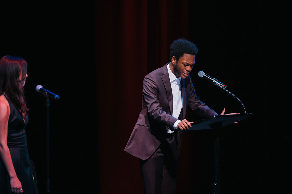 <p>TPC alum Noah E. Green speaking at the <em>Broadway in Bethesda </em>Gala. Photo by Cameron Whitman Photography. </p>